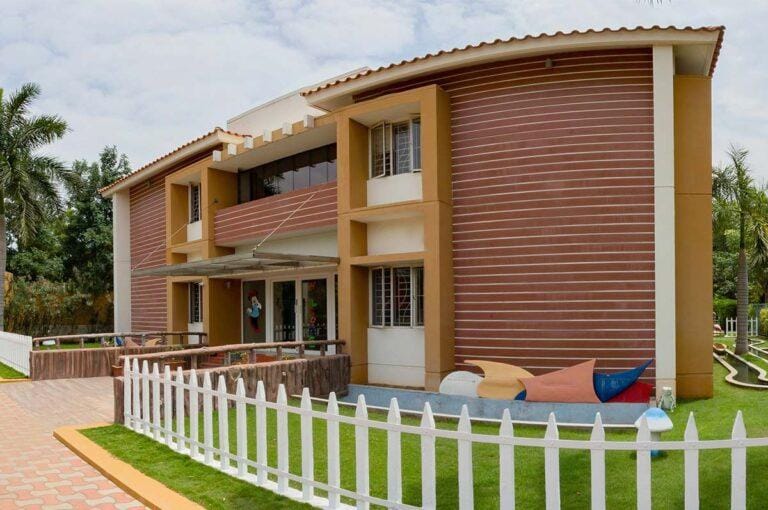 Anan school building with a white picket fence